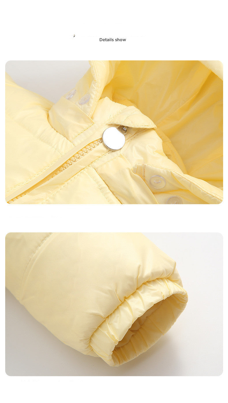 The Baby Wears White Eiderdown Over A Onesie And Down Jacket